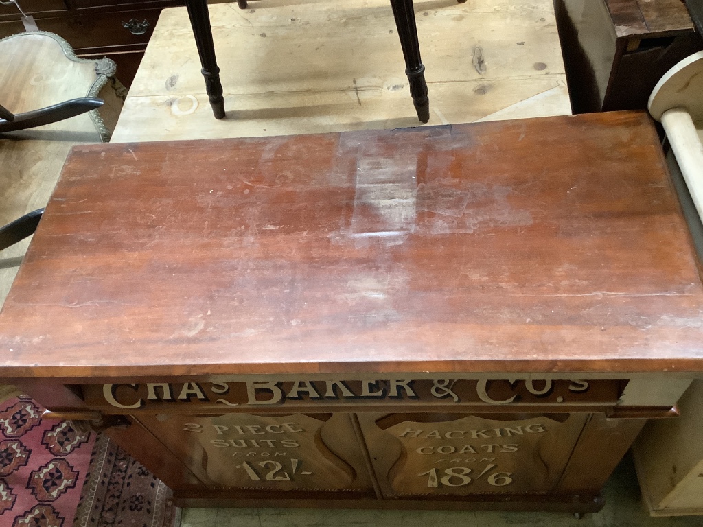 A tailor's bespoke carved mahogany shop cabinet, fitted two panelled doors, inscribed to the front in gilt lettering